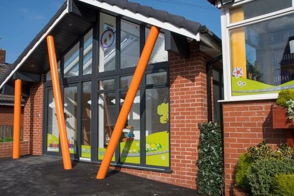 a building that has some orange poles in front of it.